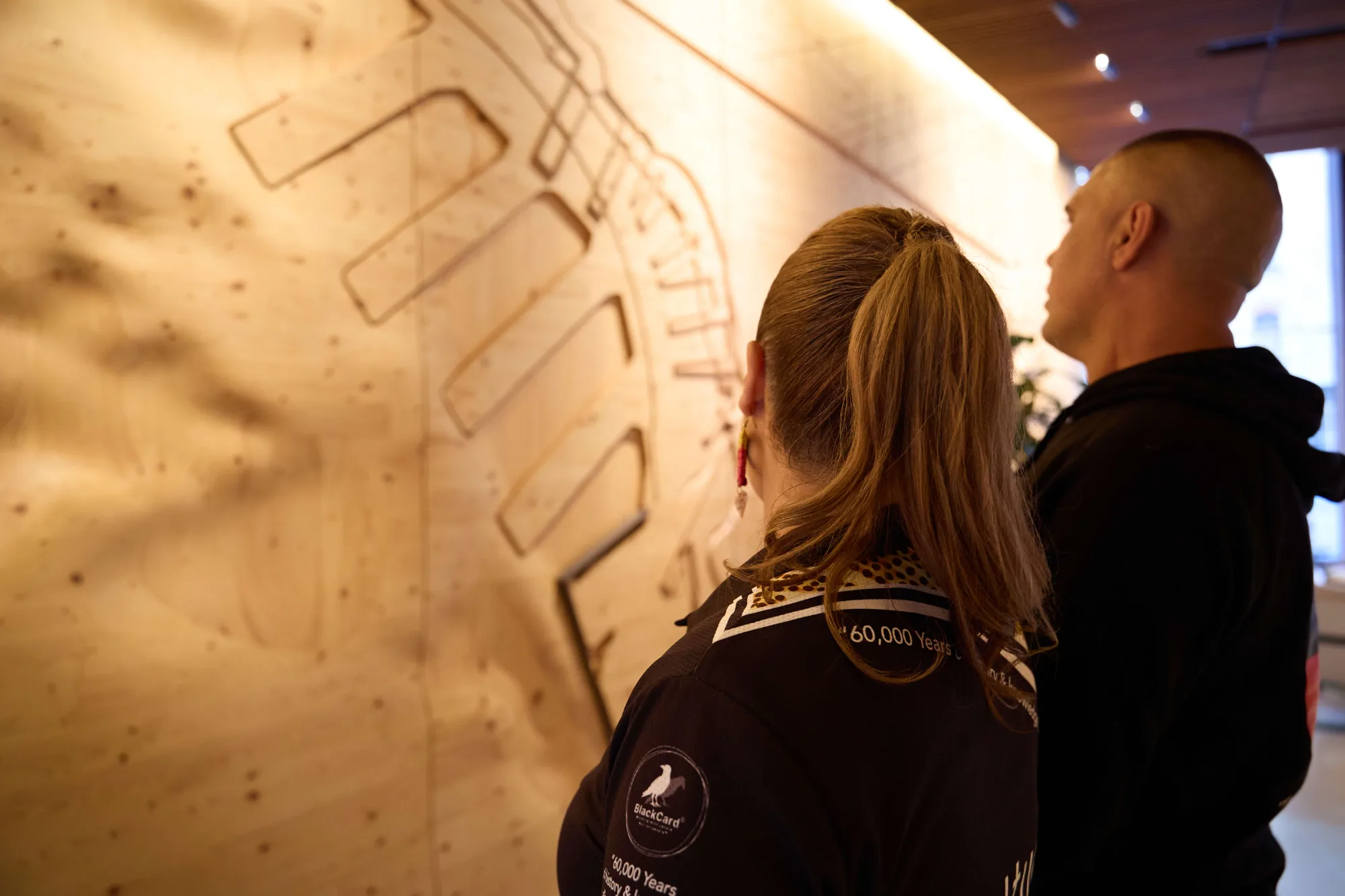 Two people viewing an artwork during a guided visit.