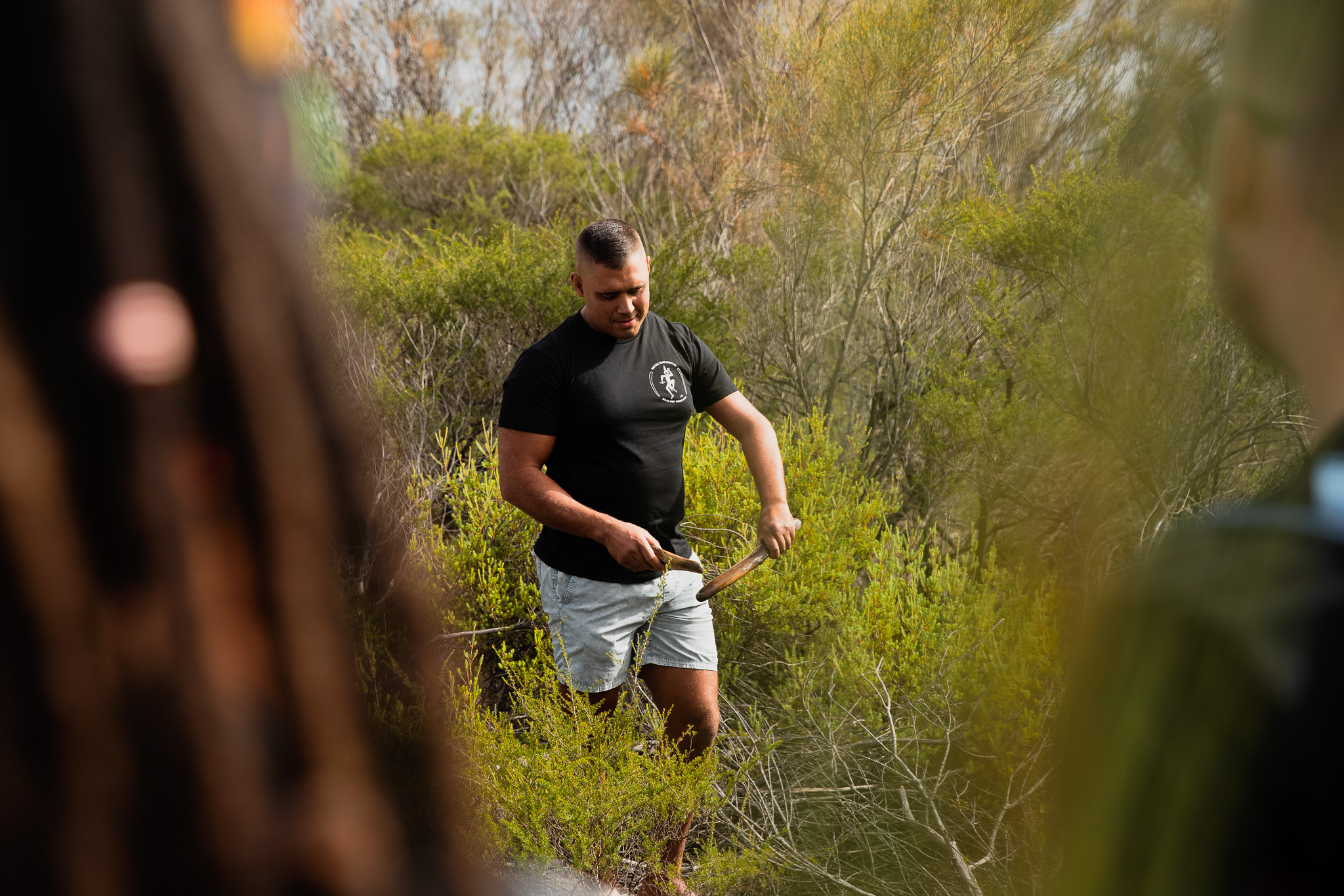 A cultural guide sharing with guests in bushland.